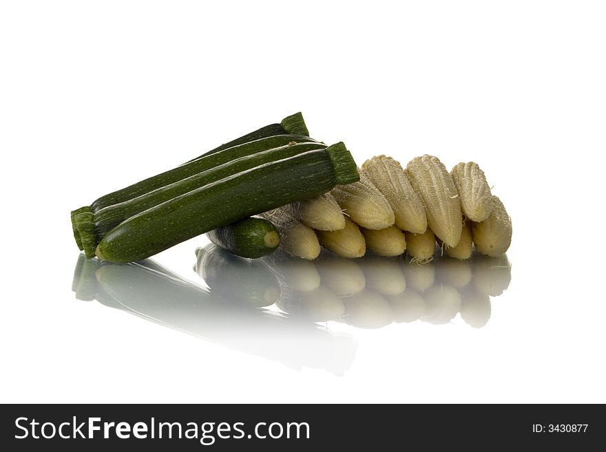 Baby zucchini and corn isolated over white background