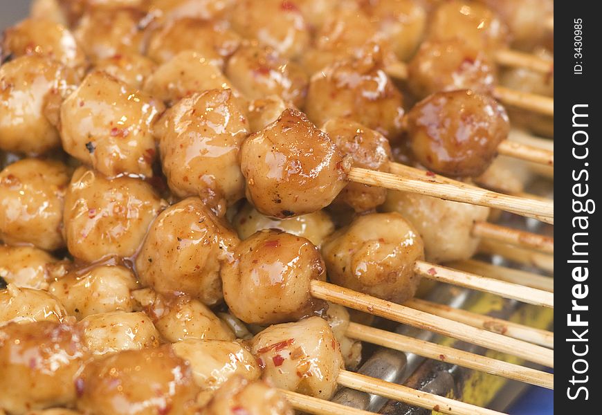 Meatballs on sticks, dipped in sweet chili sauce at a market in Thailand. Meatballs on sticks, dipped in sweet chili sauce at a market in Thailand