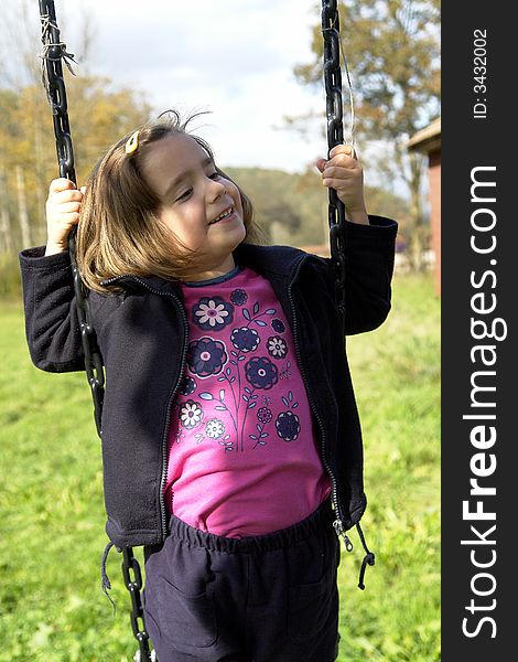 Little girl being playing on grass field. Little girl being playing on grass field