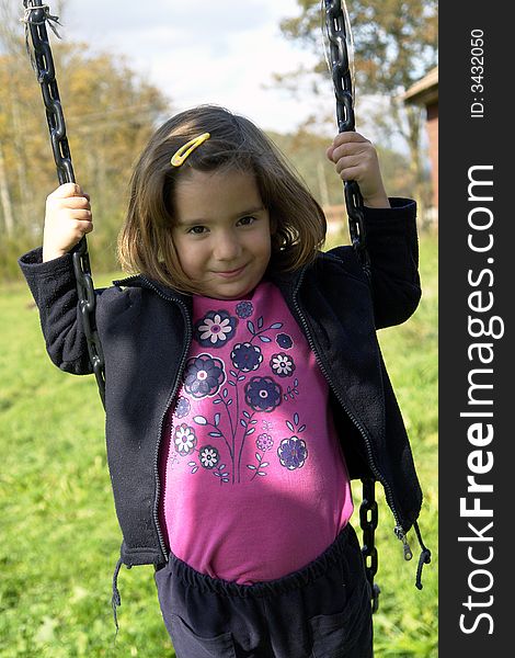 Little girl playing on grass field. Little girl playing on grass field