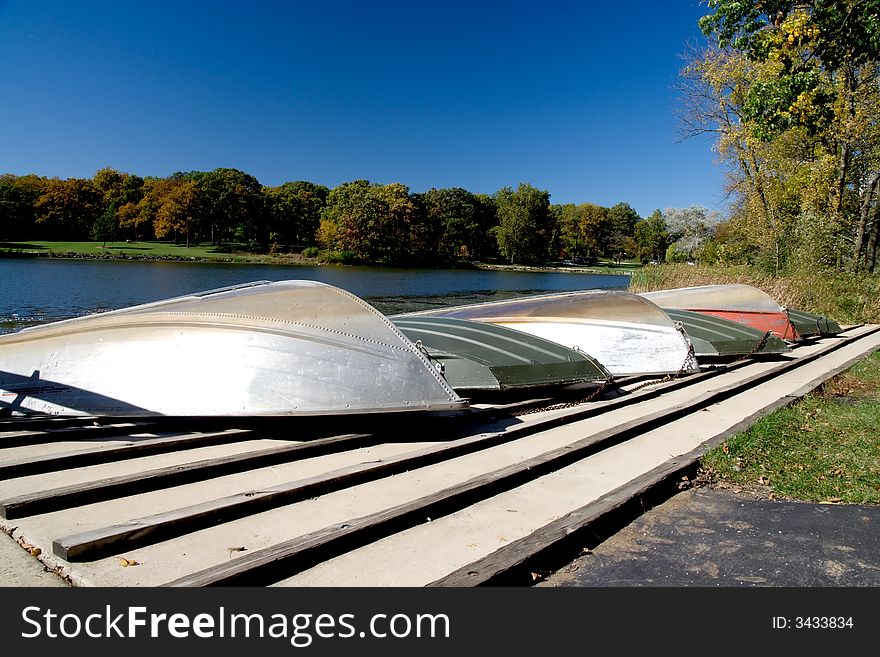 A small lake in Illinois with four small boats docked. A small lake in Illinois with four small boats docked.