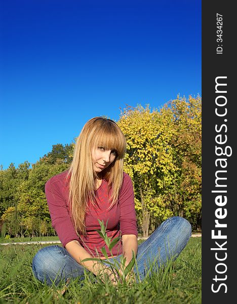 Slim shaped beautiful blond girl relaxing at park meadow. Slim shaped beautiful blond girl relaxing at park meadow