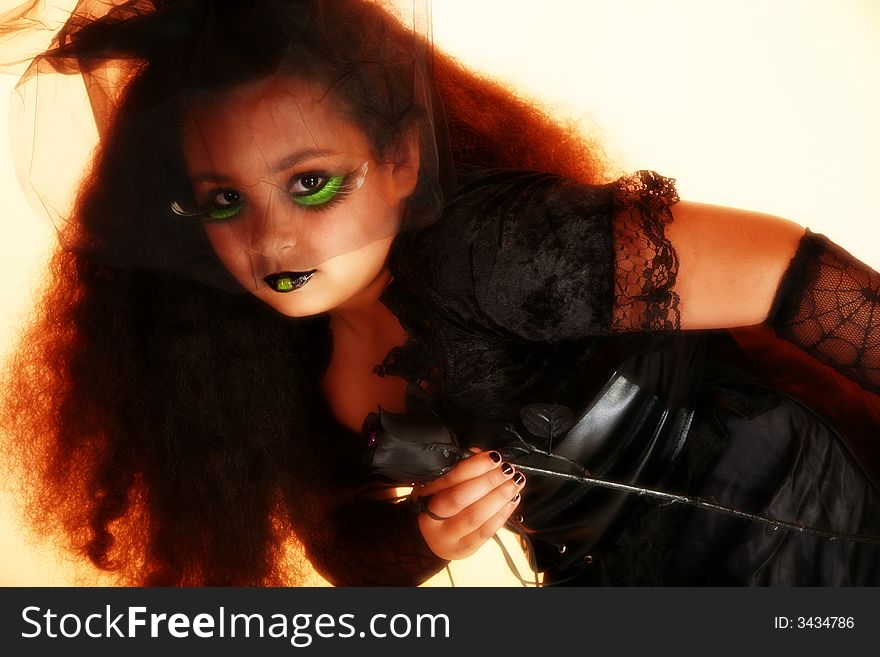 Beautiful African American ten year old girl in goth bride costume. Beautiful African American ten year old girl in goth bride costume.