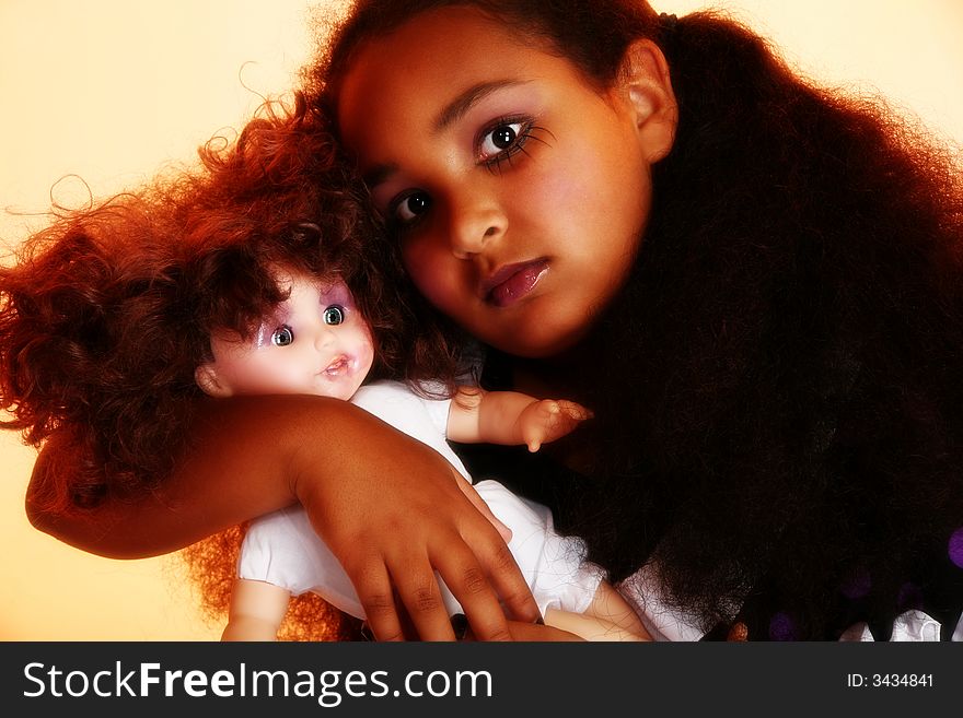 Beautiful 10 year old African Amercain girl with baby doll in goth theme.