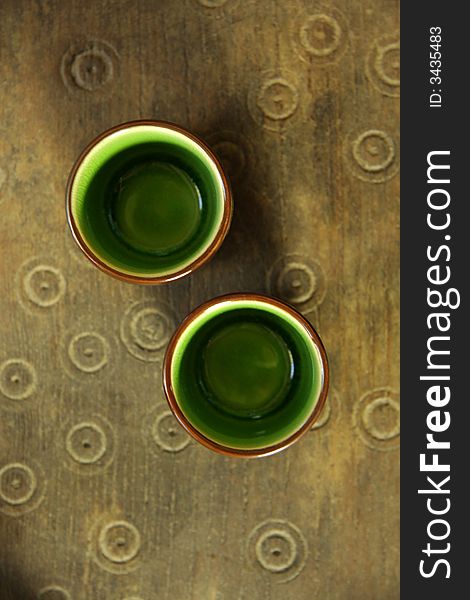 Green chinese tea cup on old wooden table. Green chinese tea cup on old wooden table