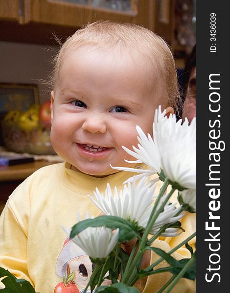 Smiling baby in the room with flowers. Smiling baby in the room with flowers