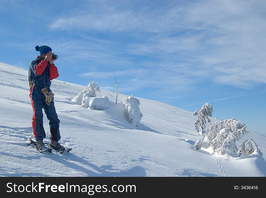 Photographer in snow mountain