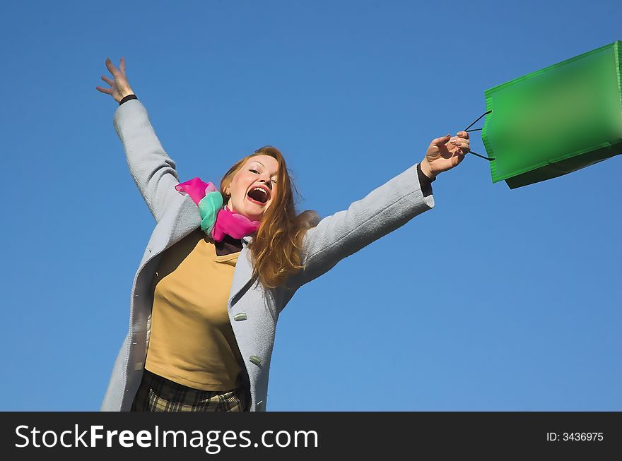 The woman with purchases on a background of the sky