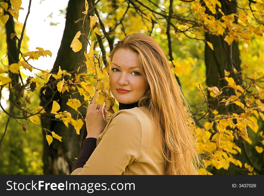 Portrait of the beautiful girl in autumn park