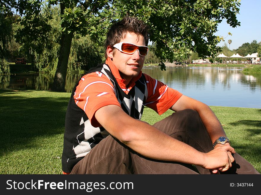 Attractive young model with white frames sunglasses in the park. Attractive young model with white frames sunglasses in the park