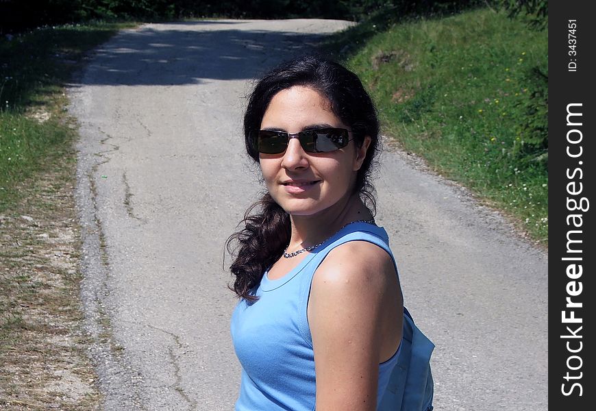 Girl Walking Up The Mountain Wearing Sunglasses