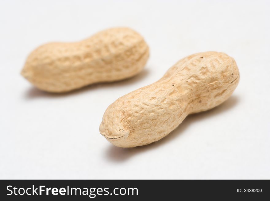 Two Peanuts On A White Background