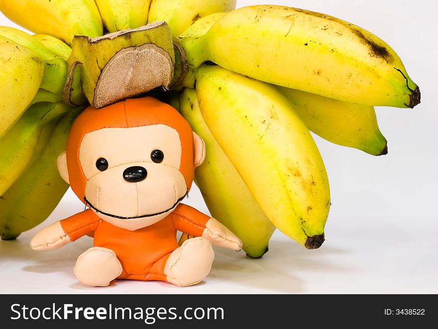 Still Life: Bananas on table top with toy monkey. Still Life: Bananas on table top with toy monkey