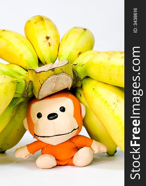 Still Life: Bananas on table top with toy monkey. Still Life: Bananas on table top with toy monkey