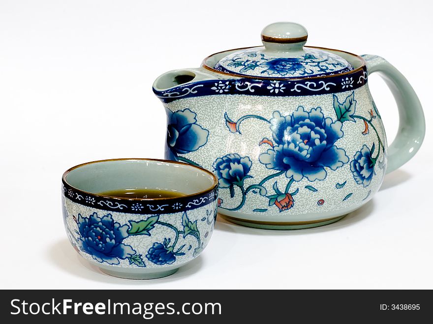 Still Life: Teapot and cup on table top. Still Life: Teapot and cup on table top