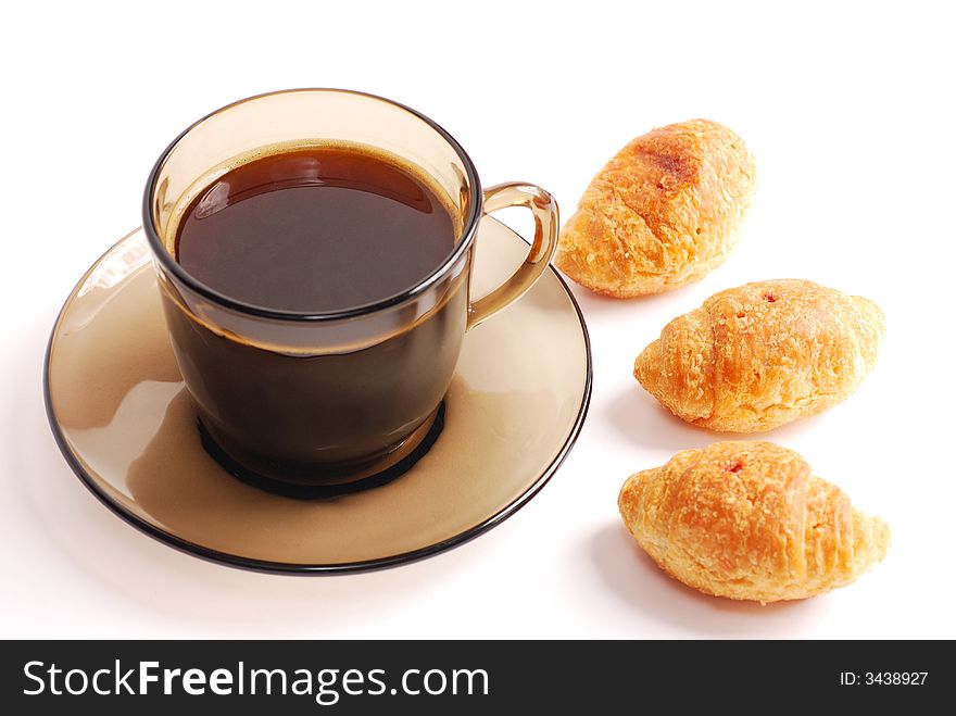 Cup of coffee with croissant close up