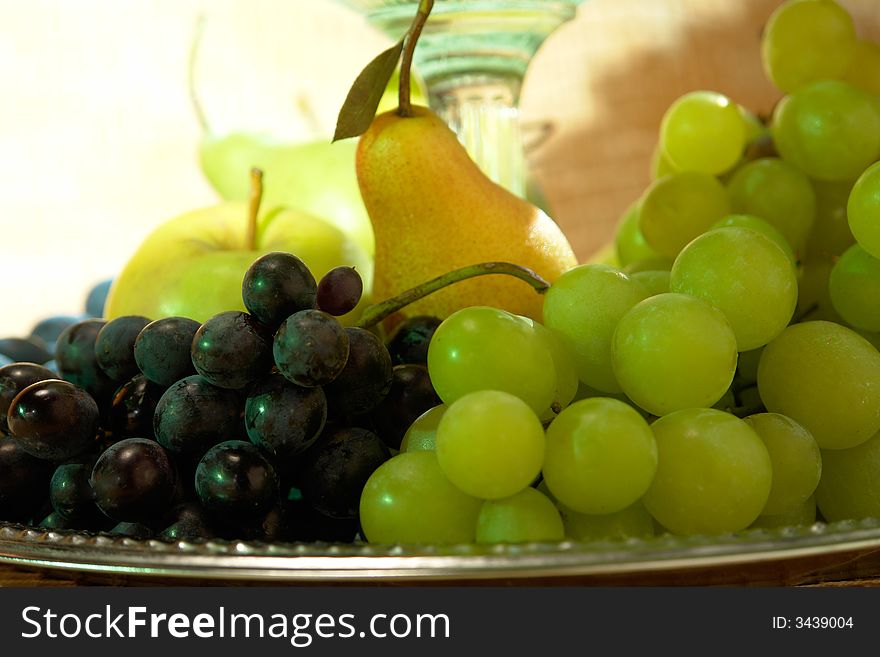 Apple and grapes on a yellow background