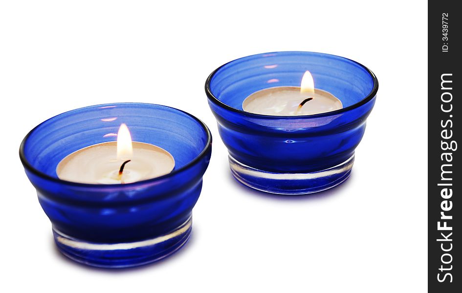 Two blue  candles isolated on the white background