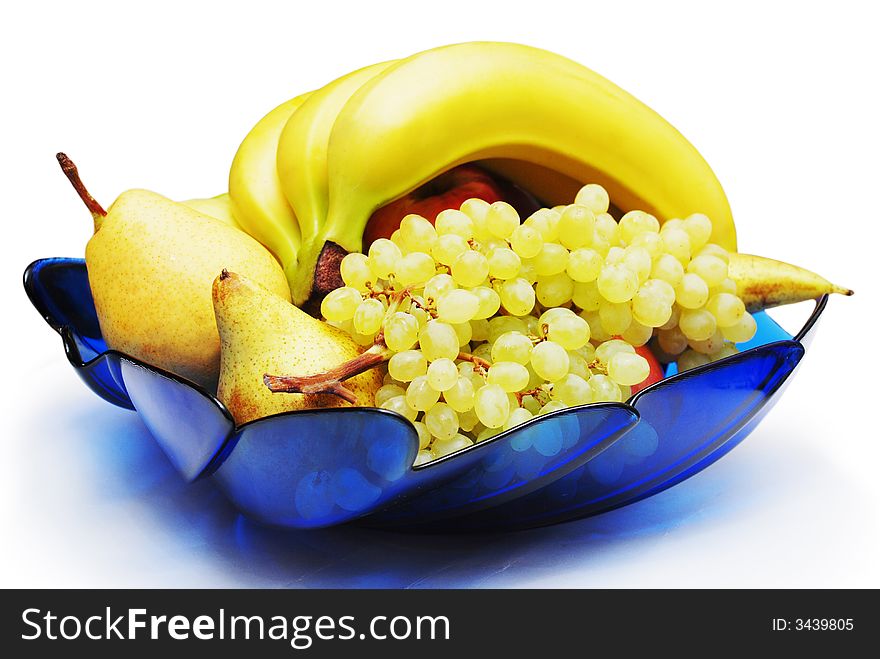 Fruits in the blue vase isolated on the white