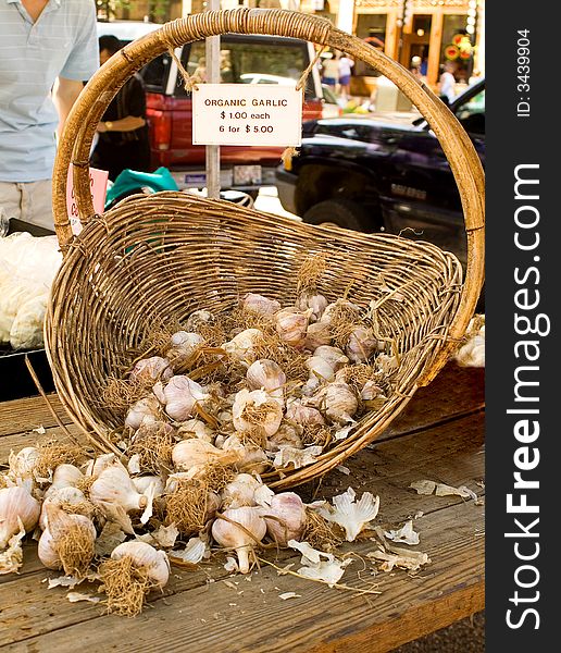 Basket of fresh, organic garlic at a local farmer's market. Basket of fresh, organic garlic at a local farmer's market