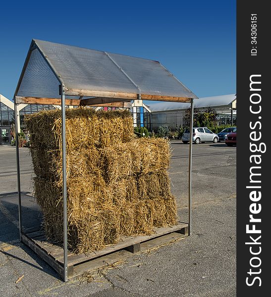 Covered Haystack in a parking lot with a nice blue sky.