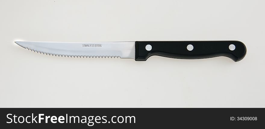 Steak knife on white counter top. Steak knife on white counter top