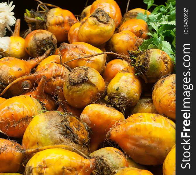 Orange beets for sale at a farmers market. Orange beets for sale at a farmers market