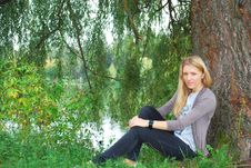The Girl Sitting Near Willow Near The Lake. Stock Photo The Girl Sitting Near Willow Near The Lake. Stock Photo