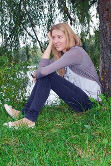 The Girl Sitting Near Willow Near The Lake. Stock Photo The Girl Sitting Near Willow Near The Lake. Stock Photo