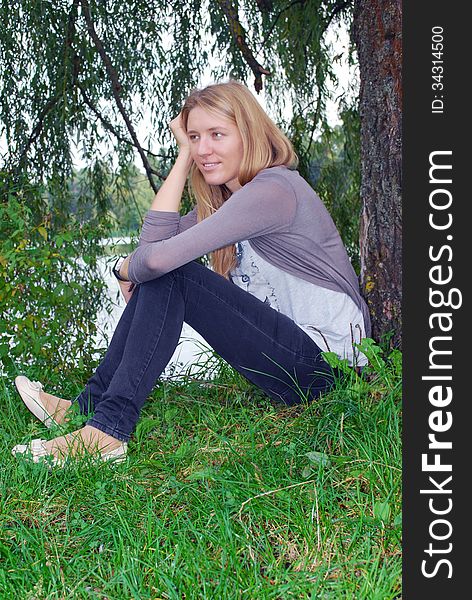 The Girl Sitting Near Willow Near The Lake.