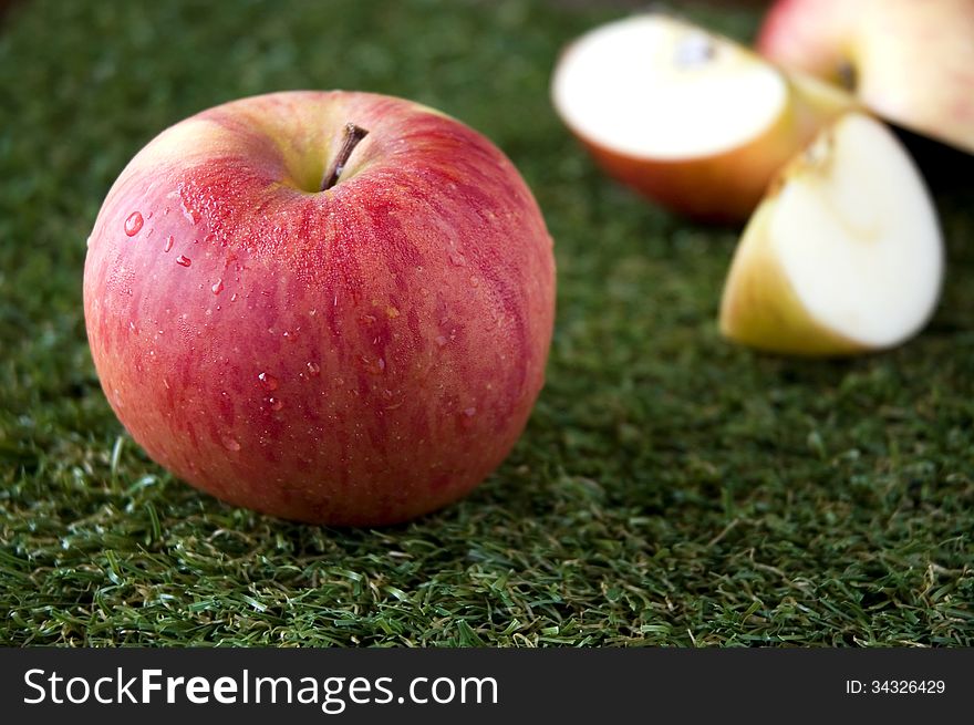 Close up fresh apple and apple slices on background