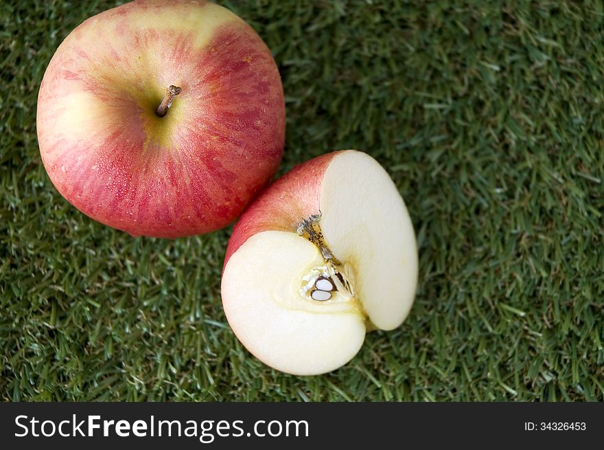 Close up top of fresh apple on grass