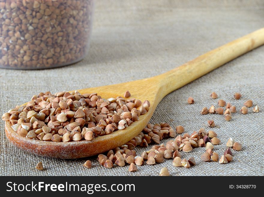 Buckwheat groats in a wooden spoon