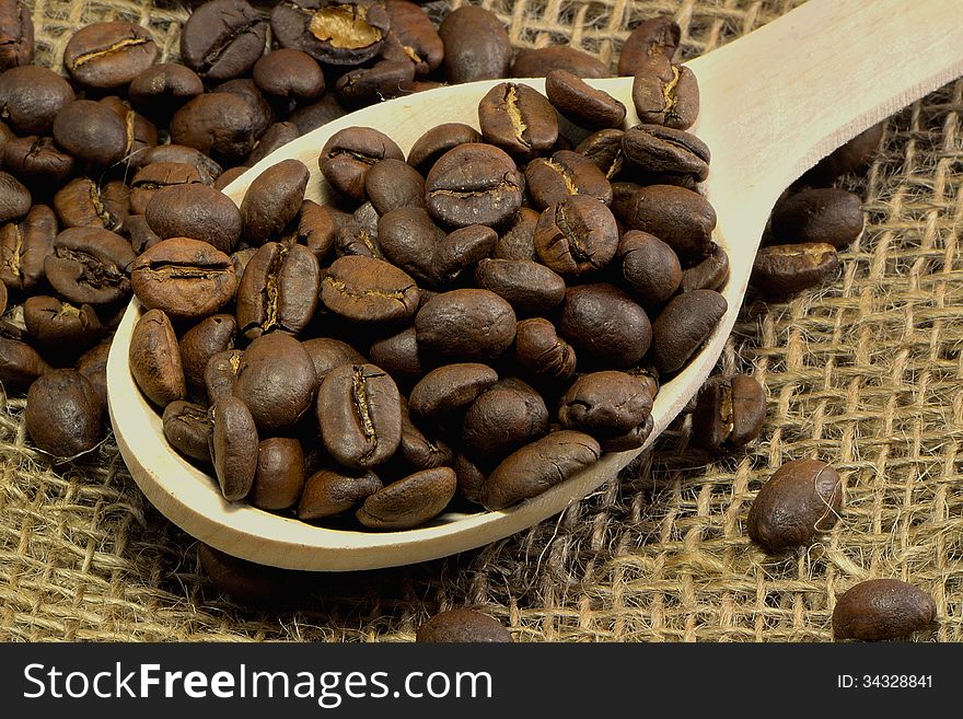 Coffee beans in a wooden spoon