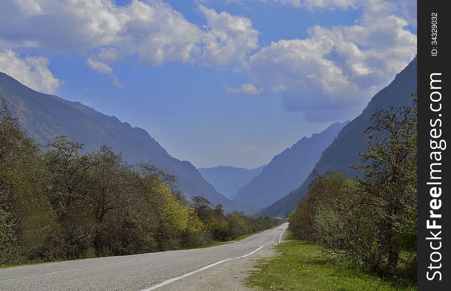 Road stretches into the distance among the mountains. Road stretches into the distance among the mountains