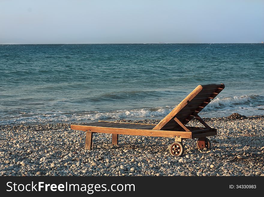 Water beach coast line and wooden chair or bed photo. Water beach coast line and wooden chair or bed photo.