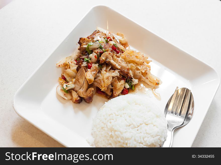 Spicy asian chicken with rice .