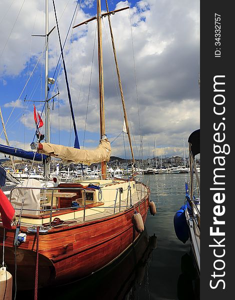 Moored on the waterfront, luxury wooden sailboat