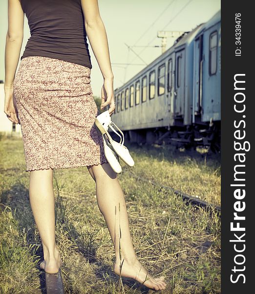 Woman waiting for the train at an old railway station. Woman waiting for the train at an old railway station