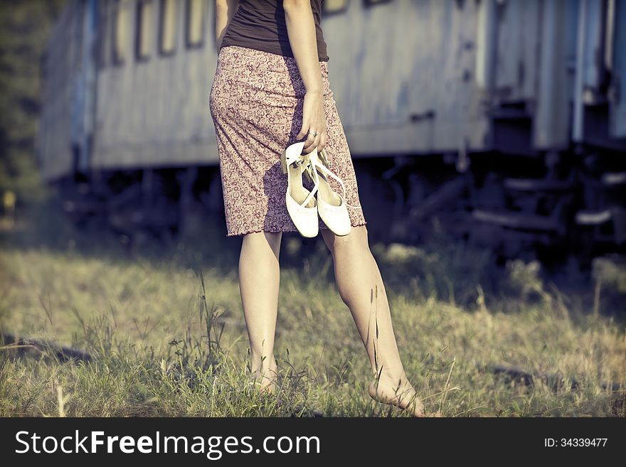 Woman waiting for the train at an old railway station. Woman waiting for the train at an old railway station