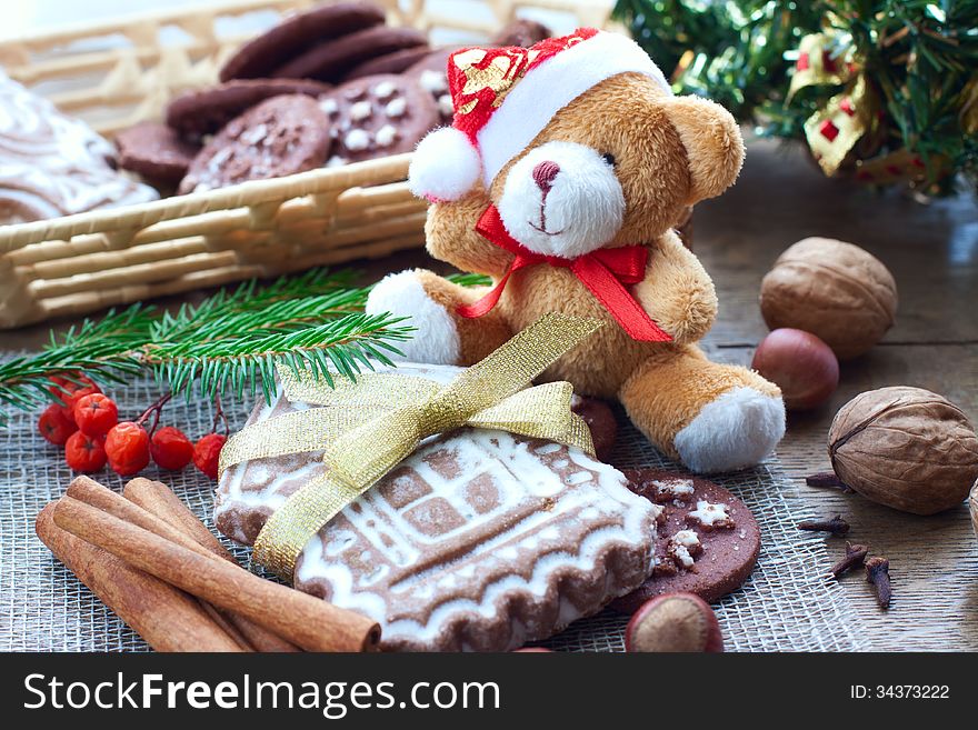 Christmas greetings with gingerbread and biscuits, bear and Christmas tree