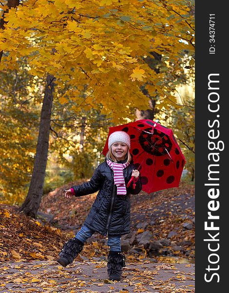 Little girl with umbrella outdoor