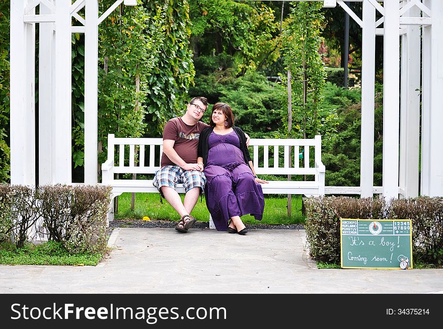 Happy pregnant women with her husband in the park. Happy pregnant women with her husband in the park.