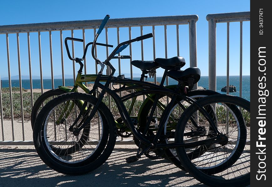 Three dilapidated beach bikes with background of the blue sea and sky. Three dilapidated beach bikes with background of the blue sea and sky