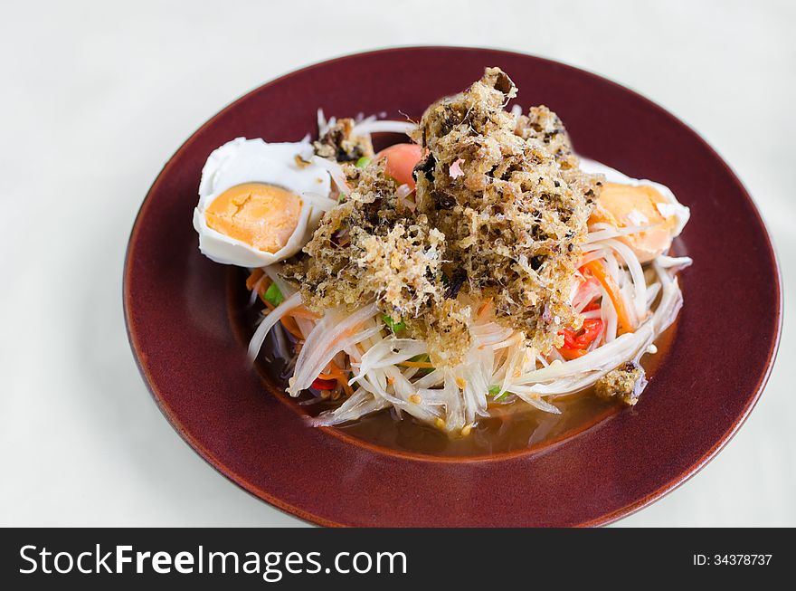 Papaya salad with crisp fried catfish and salted egg