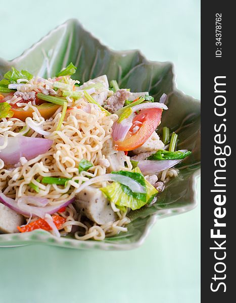 Thai dressed spicy salad with pork, tomatoes and noodle.