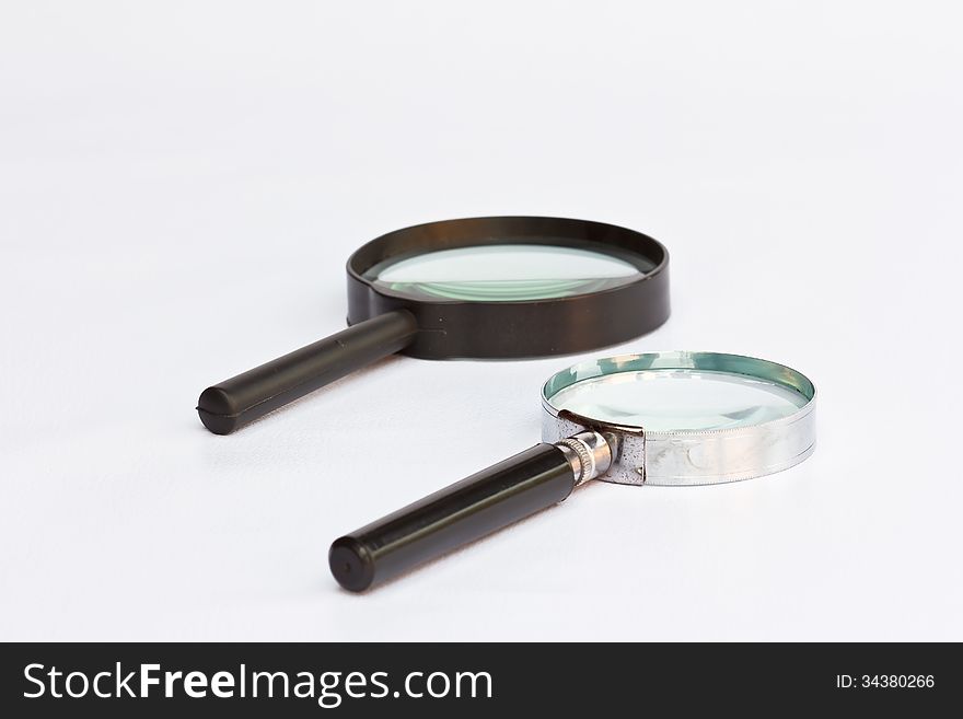 The old two magnifying glass on white background. The old two magnifying glass on white background.