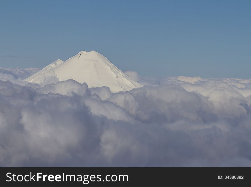 White peak in the clouds. Chile