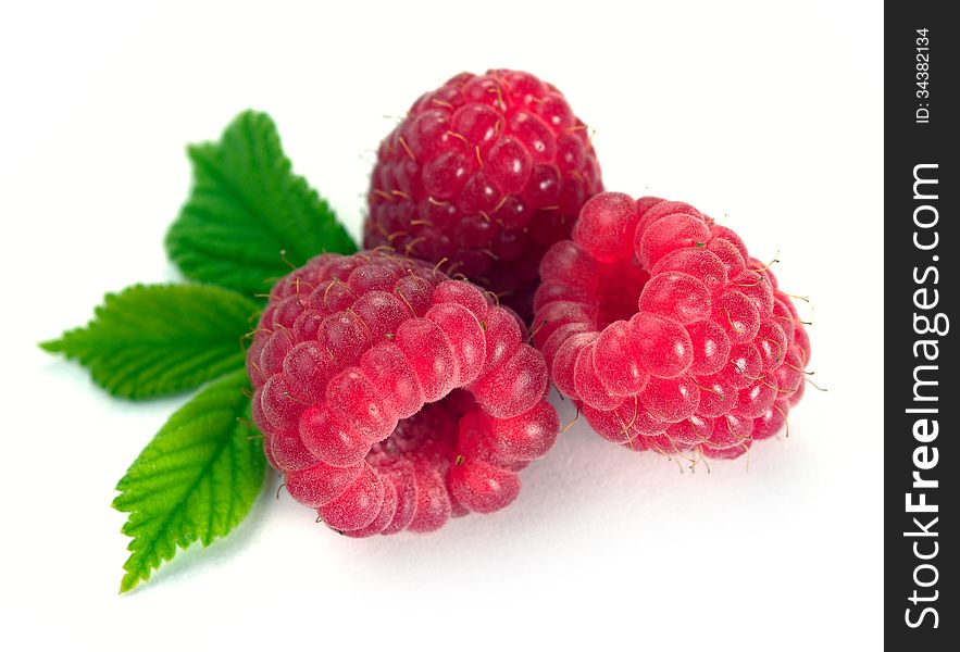 Raspberry with leaves on a white background