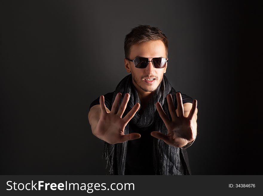 Portrait of a handsome guy, wearing sunglasses, Low-key image